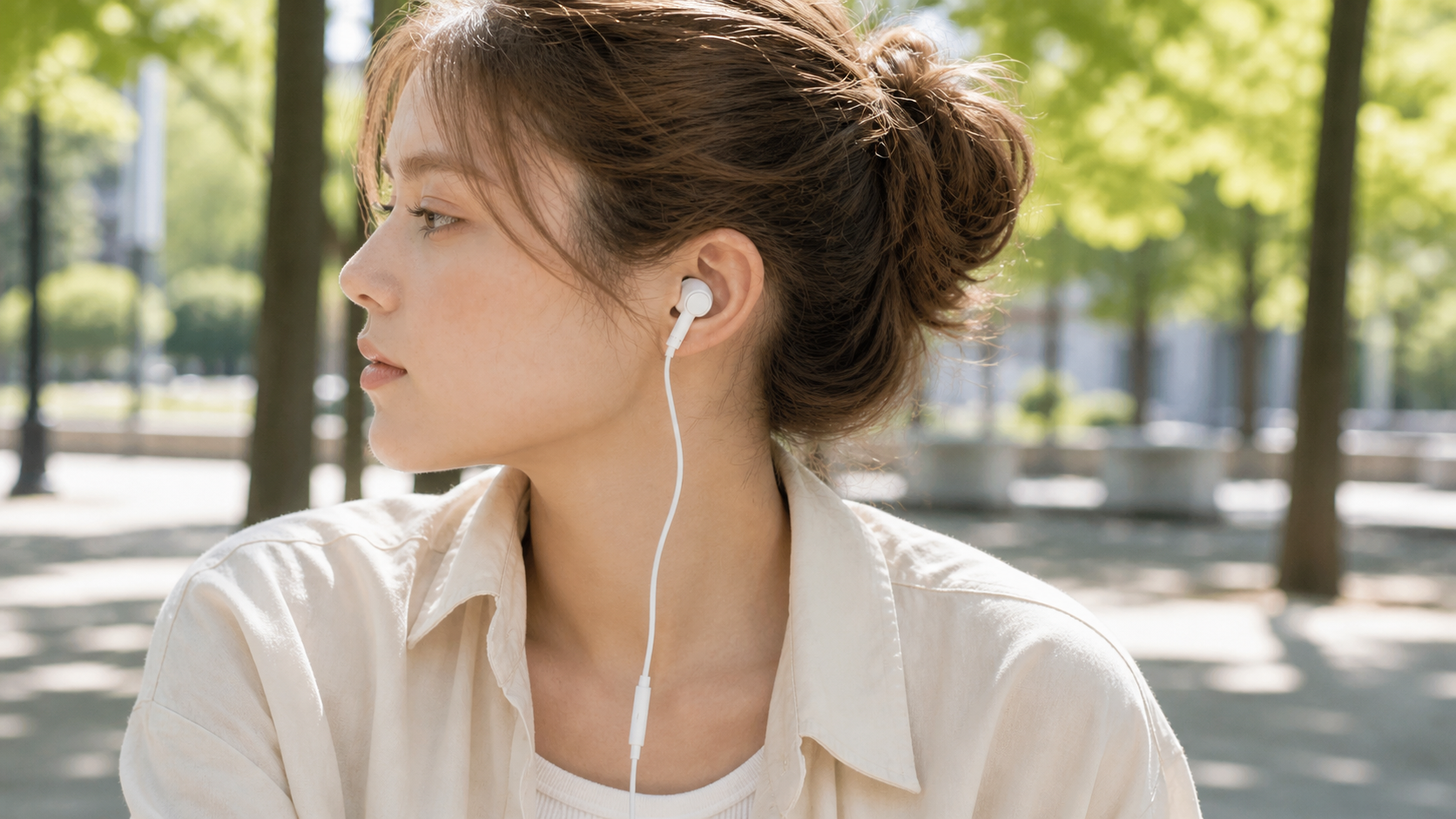 Person wearing AUDR wired USB-C earbuds outdoors